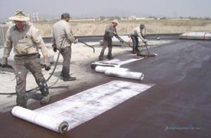 men laying rubber for roof